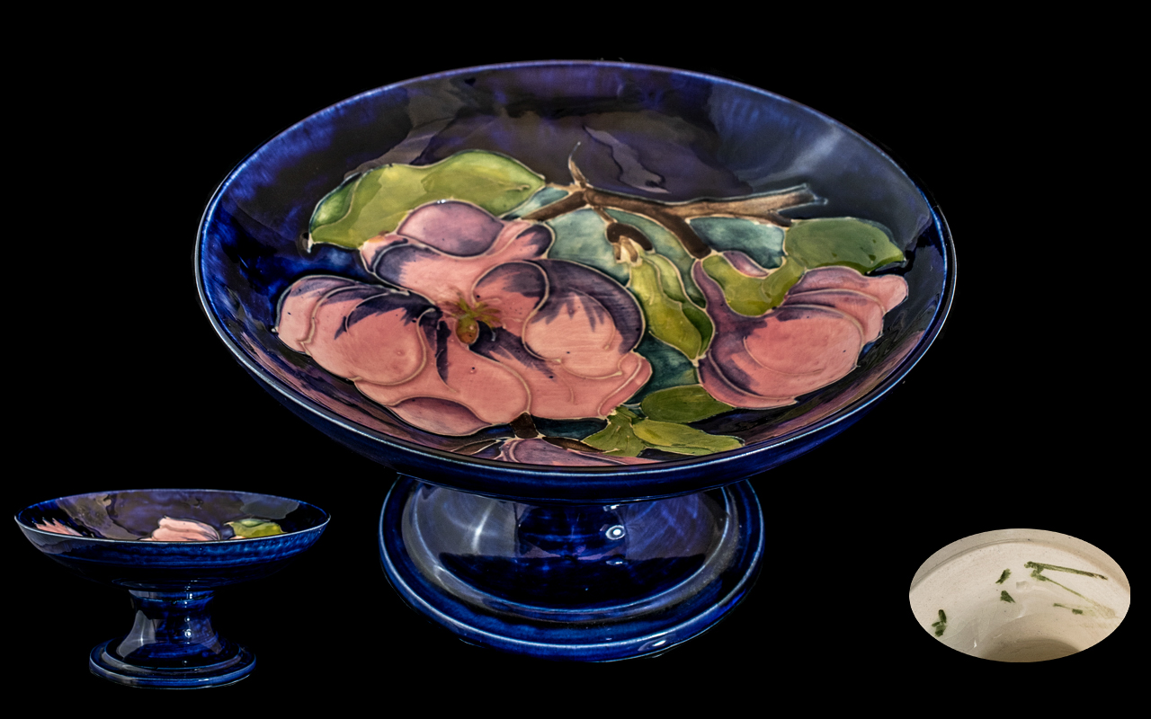 A Moorcroft Magnolia Pattern Tazza on a blue ground. Height 3 1/2 inches, Diameter 7 inches.