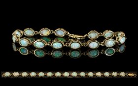 Ladies Attractive 9ct Gold Opal Set Line Bracelet, Set with 15 Opals of Excellent Colours. Est