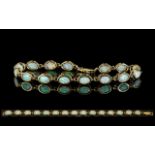 Ladies Attractive 9ct Gold Opal Set Line Bracelet, Set with 15 Opals of Excellent Colours. Est