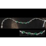 A 14ct White Gold Emerald and Diamond Bracelet central links set with alternating round cut
