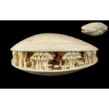 Japanese 19th Century Carved Ivory Clam Shell with Carved Images of Figures, Trees, Buildings,