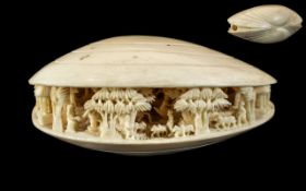 Japanese 19th Century Carved Ivory Clam Shell with Carved Images of Figures, Trees, Buildings,