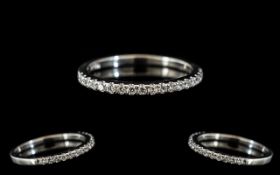 A Platinum Diamond Half Eternity Ring set with round, modern brilliant cut diamonds,