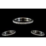 A Platinum Diamond Half Eternity Ring set with round, modern brilliant cut diamonds,