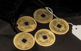 A Pouch Containing Five Chinese Metal Gaming Tokens, 4cm diameter.