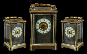 An English Brass Carriage Clock of typical form, white chapter dial with Arabic Numerals,
