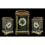 An English Brass Carriage Clock of typical form, white chapter dial with Arabic Numerals,