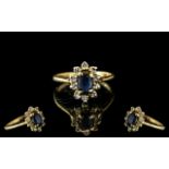 Ladies 9ct Gold Sapphire & Diamond Dress Ring, oval sapphire surrounded by small diamonds in a