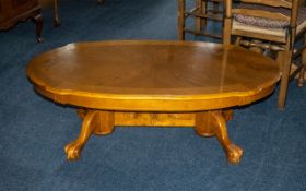 Oval Polished Oak Coffee Table, raised on two pedestals with carved stretcher and played legs at