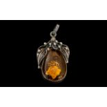 A Silver Art Nouveau Style Amber Set Pendant Drop height with bale 2 inches.