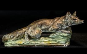 A Large Decorative Figure of a fox crouching on a rock. Measures 50 cms in length by 30 cms in