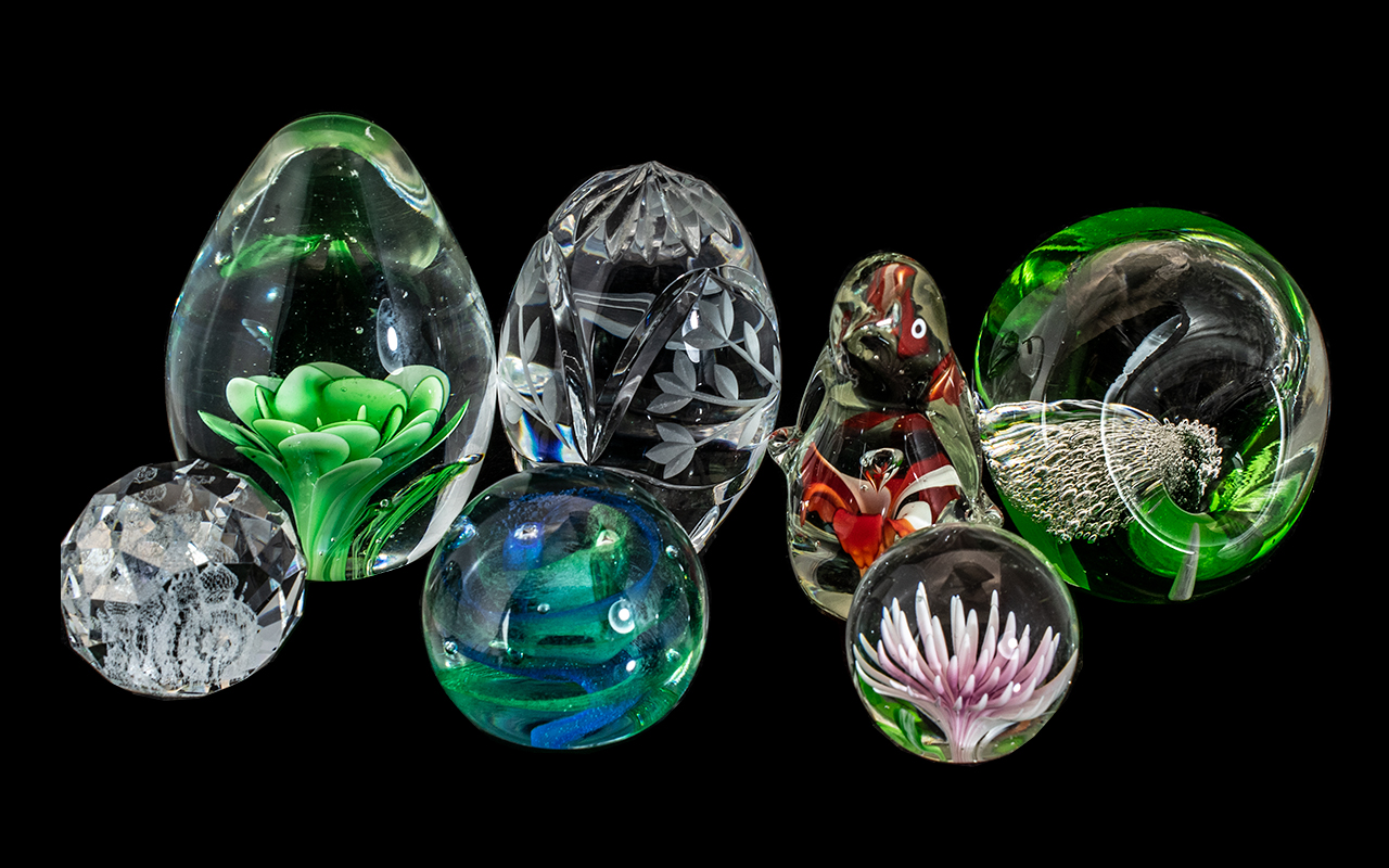 Collection of Seven Paperweights, including a Caithness Twirl, penguin glass with red flower at