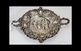 A Silver Embossed Three Handled Dish, depicting cherub figures, foreign import hallmark for 1896.