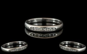 A Platinum Diamond Set Eternity Ring, channel set with seven round modern brilliant cut diamonds,