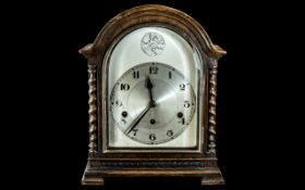 An Early 20th Century Oak Cased Mantle Clock, silvered dial with Arabic numerals,