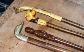 Four Vintage Walking Sticks, comprising sticks with decorative handles including a British Bulldog,