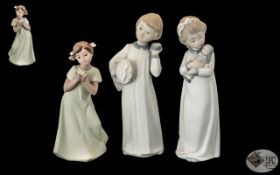 Nao by Lladro Trio of Hand Painted Figures ( 3 ) Comprises 1/ Girl In Nightdress Holding a Doll.