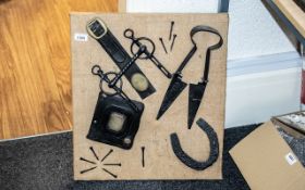 Farriers Antique Tool Display Mounted on Board, comprising shears, horse's bit, horseshoe, tacks,