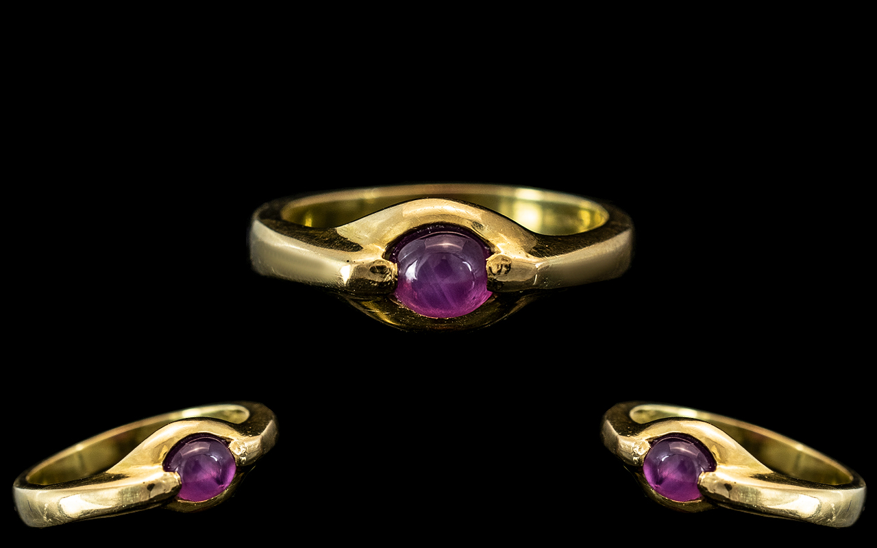 18ct Gold Amethyst Set Dress Ring, Central cabachon amethyst, shank stamp 750.