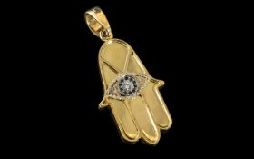An 18ct Gold Diamond Pendant in the form of a Hamsa Hand, central design set with round modern