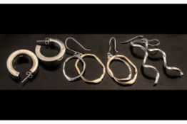 Three Pairs of Chunky Silver Earrings, a collection of designer style earrings of large size, all