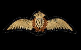 WW2 RAF Pilot’s Wings of wool embroidery over padded blue ground.