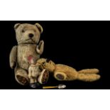 An Early 20th Century Straw Filled Jointed Teddy Bear, together with one other,
