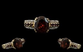 Ladies 9ct Gold Garnet Set Dress Ring, with central garnet and illusion set shank, size S.