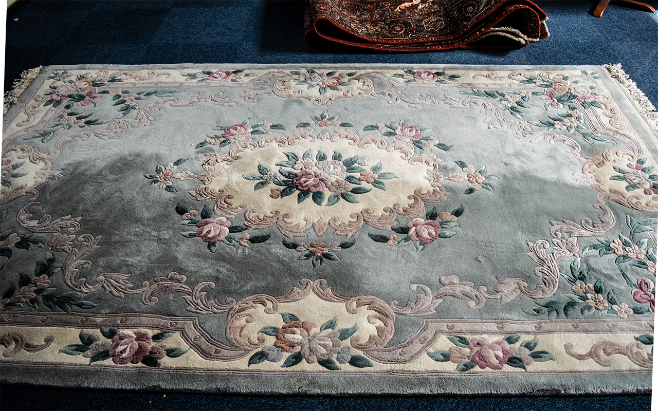 Large Quality Chinese Rug, shades of blue floral on cream background, with fringing.