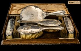 A Silver Backed Vanity Set comprising of a hand mirror,
