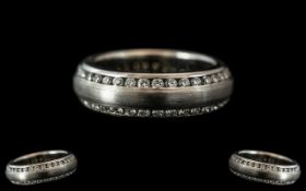 A Platinum Diamond Set Wedding/Eternity Ring, channel set edges with two continuous rows of round