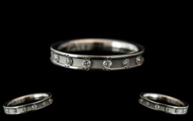 A Platinum Diamond Set Wedding/Eternity Ring, with a brushed gold centre set with seven round