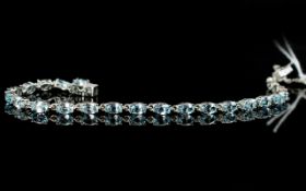 Sky Blue Topaz Tennis Bracelet, an articulated line of oval cut, sparkling, sky blue topaz,