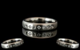 A Platinum Diamond Set Wedding/Eternity Ring, set with seven alternating round brilliant cut and