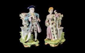 Pair of Continental Spill Vases with figures, 12'' tall, depicting a gentlemen and lady in