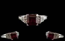 Ruby and Zircon Ring, a square cut, 2.5ct ruby solitaire (of a brighter rich red than it appears