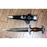 Military Reproduction German Dagger & Sheath, with winged insignia and swastika, in leather sheath.