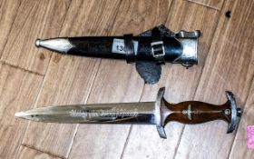 Military Reproduction German Dagger & Sheath, with winged insignia and swastika, in leather sheath.