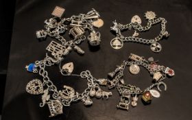 A Collection of Four Silver Charm Bracelets loaded with various charms gross weight 125 grams.