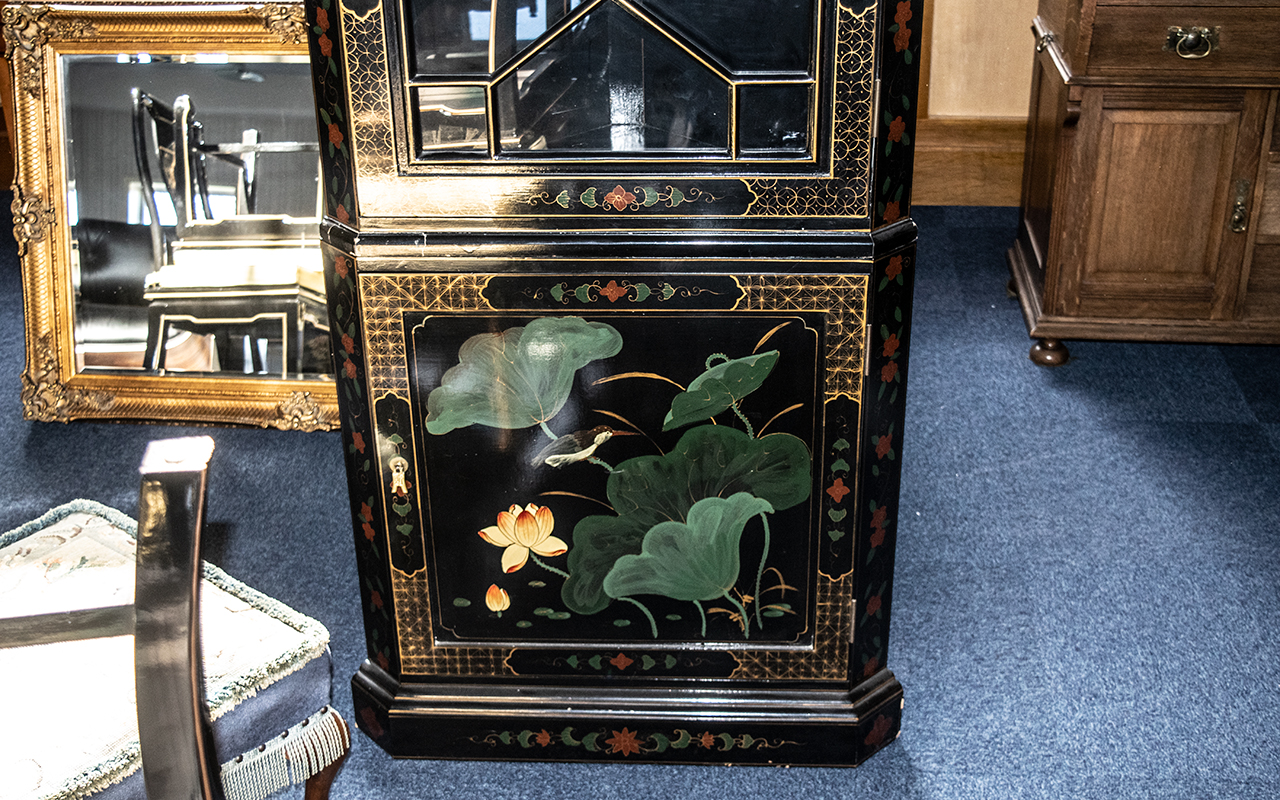 A Chinoiserie Decorated black lacquered corner unit with gilt highlights and landscape decoration. - Image 2 of 3