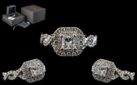 An 18ct White Gold Diamond Ring, set with a central Princess cut diamond,