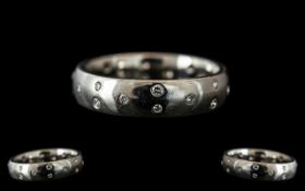 A Platinum Diamond Set Wedding/Eternity Ring, set with 23 round modern brilliant cut diamonds,