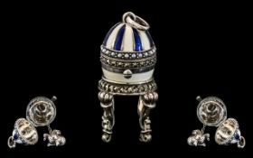 Faberge Style Silver and Enamel Egg on Stand, a silver egg with blue and white enamelling,