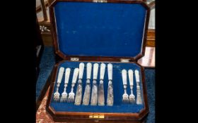 Walnut Canteen Containing Mother of Pearl handled fish knives and forks. Eleven knives and forks.