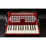 Piano Accordion by Chanson, red, in fitted carrying bag.