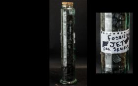 Tall Glass Pot containing Fossilised Pieces of Jet, for jewellery making etc.