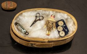 A Miniature Wooden Sewing Box, complete with miniature, penknife, scissors, jointed figure,