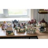 A Collection of Novelty Teapots including a set of two Western house collectables,