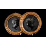 A pair of 19th century French Bois Durci medallions of "Queen Victoria" and "Prince Albert".