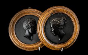 A pair of 19th century French Bois Durci medallions of "Queen Victoria" and "Prince Albert".